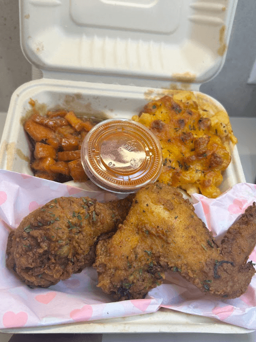 Soul food catering plate from Winkie's: crispy fried chicken, baked macaroni and cheese, and glazed candied yams in a takeout-style container